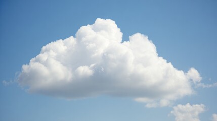 Fluffy cumulus cloud against a clear blue sky, creating a serene summer atmosphere.
