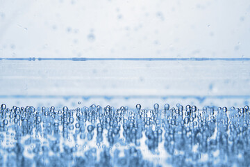 Soda water with bubbles of gas in glass, closeup