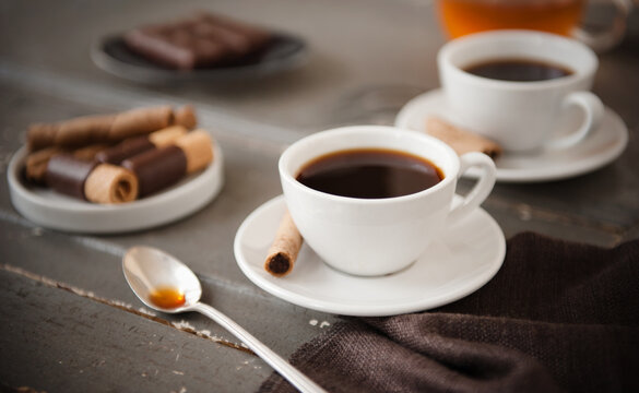 Cups of coffee with chocolate Pirouettes cookies