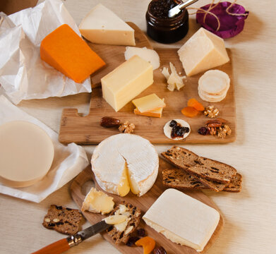 Assorted gourmet cheeses with fruit and nuts