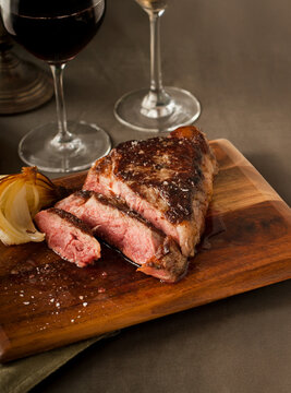 Steak dinner with roasted onion and red wine