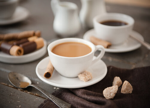 Cups of coffee with chocolate Pirouettes cookies