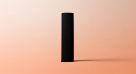 A sleek, black rectangular object stands upright against a soft, -colored gradient background, creating a minimalist and elegant product shot.
