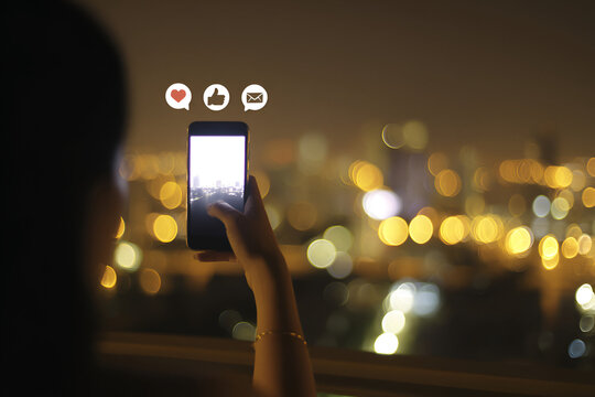 Nighttime city views captured on smartphone with like, comment and message icons.