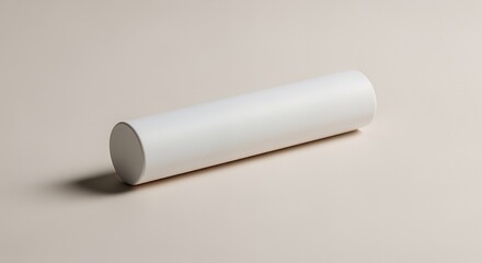A minimalist studio shot shows a cylindrical object, possibly a container or tube, resting on a light beige .