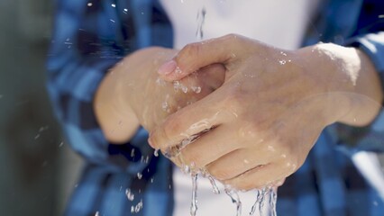 wash your hands with clean water, bokeh, wash germs with a clean transparent stream of water, save...