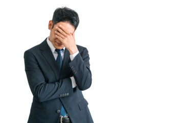 ショック・ストレスで頭を抱えるスーツ姿のアジア人中年ビジネスマン（困る・落ち込む・疲労・リストラ）
