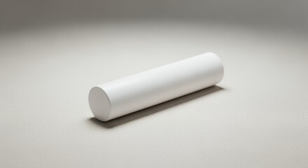 A pristine white cylinder rests on a light gray , showcasing its smooth texture and simple elegance.