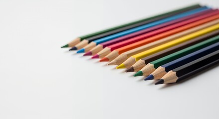 A vibrant collection of colored pencils arranged in a neat row, showcasing their sharpened points and diverse hues on a clean white background.