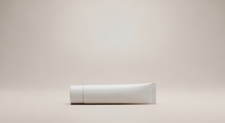 Fototapeta premium A pristine white tube of skincare cream or lotion sits on a minimalist off-white , ready for use or display.