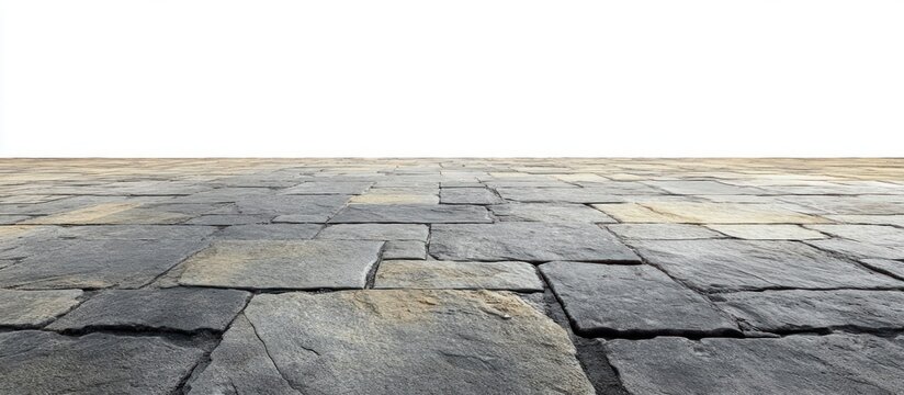 Close-up view of an uneven stone pavement with large weathered rectangular slabs stretching into the distance under natural light