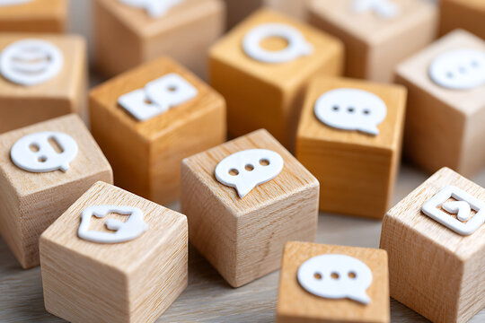 Creative Display of Wooden Blocks Featuring Social Media Icons on a Light Wooden Surface in a Playful Arrangement