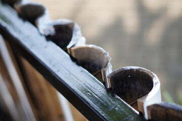 Several bamboo poles split in half and glued to iron as a natural fence