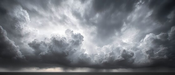 Dramatic dark storm clouds gathering over a calm ocean horizon under a moody sky