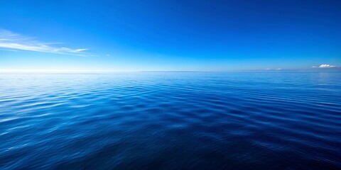 The deep blue ocean stretches out to meet the clear blue sky