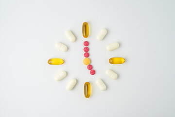 Clock made of pills capsules, pills form a circle, omega, vitamins, Cod liver oil, supplements