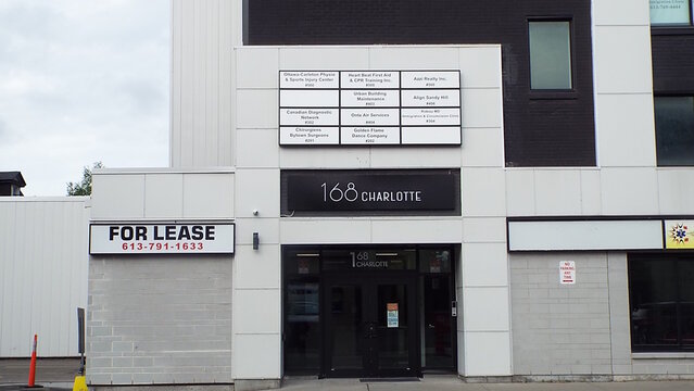 Ottawa, ON, Canada-July 21,2025: The facade of "168 CHARLOTTE ST." with various businesses such as "Ottawa Carleton Physiotherapy and Sports Injury Center" and "Canadian Diagnostic Network."