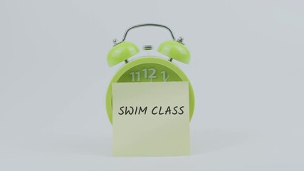 Swim Class word written on a sticky note placed in front of a green ringing clock on white background, symbolizing swimming lessons, fitness, and scheduled activity concept illustration