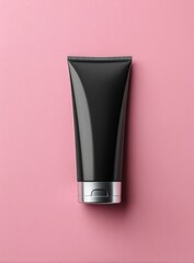 Black tube with a silver cap set against a pink backdrop, creating a modern, minimalist composition. Simple, clean lines and contrasting colors highlight the product's form