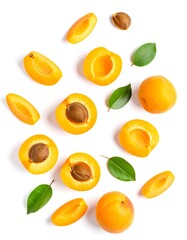Apricot slices and leaves arranged on a white background