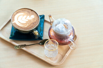 Hot coffee on wooden table, The best cappuccino fresh coffee with smoke. Porcelain cup of coffee on table with hot tea, Top view with space for text. Industrial food and drinks concept.