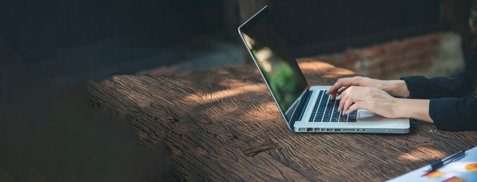 Banner Asian Woman using laptop working from home online meeting in home office. Banner Happy relax time asian business woman typing keyboard notebook laptop Smiling at home office with copy space