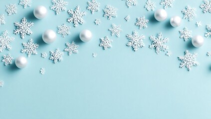 Delicate snowfall. Snowflakes & pearlescent orbs descend across a pale blue backdrop. Minimalist, airy, cold, wintery, space to below. Festive holiday concept