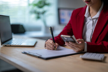 She is multitasking, possibly working on a project or responding to an email