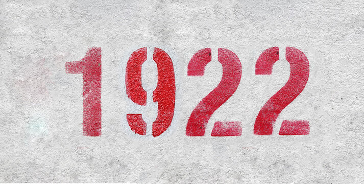 red spray-painted number 1922 sprayed onto a white wall.