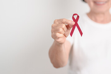 Elderly with Burgundy Ribbon for March Multiple Myeloma Cancer Awareness month, September Sickle Cell Anemia, Headache and Migraine week, April world Meningitis day, October Hospice  Palliative care