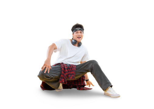 A young male dancer with a sporty look demonstrating breakdance moves. The dancer is crouched down on the ground while smiling.on png background