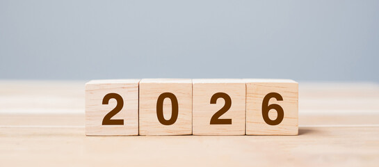 wooden cube block with 2026 text on table background. Resolution, plan, review, goal, start and New Year holiday concepts