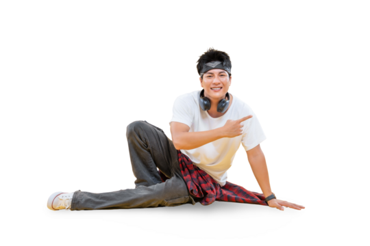 A cheerful young man posing elegantly and gesturing. He is wearing casual clothes and headphones around his neck on png background