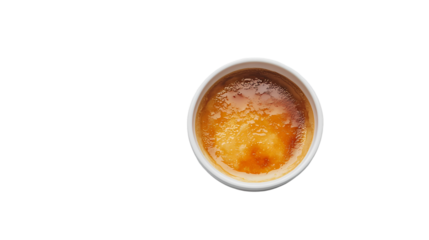 A top down of a creme brulee in a white ramekin isolated on white background