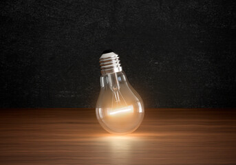 Concept of light bulbs lighting on brown wooden floor in dark color room