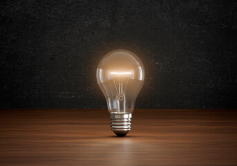 Concept of light bulbs lighting on brown wooden floor in dark color room