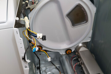 A broken heating element on a dryer being repaired 
