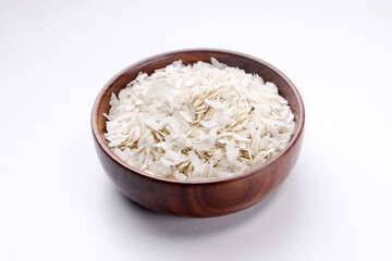 Indian food called white poha jada in wooden bowl isolated on white background 