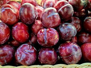 Red plum fruits piled together
