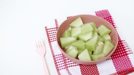 Green melon fruit on wooden plate ready to eating	