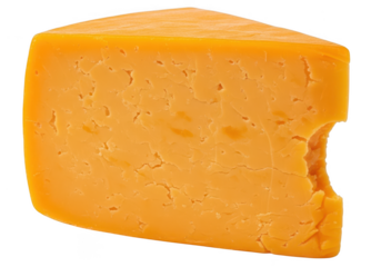Close up of a wedge of vibrant orange cheddar cheese with a bite taken out food dairy