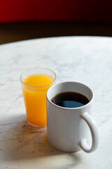 Coffee, Orange Juice and Thermos on Marble Table in Café Setting