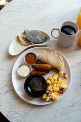 Traditional Central American Breakfast with Scrambled Eggs, Plantains and Black Beans