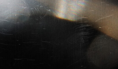 grainy colorful warm rainbow red light leaks on black background with dust texture. abstract damaged scratched retro film analog effect for using over photos as overlay or screen filter