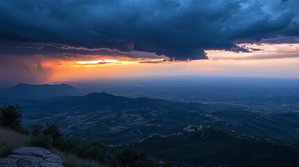 Dramatic sunset over mountain range, storm clouds