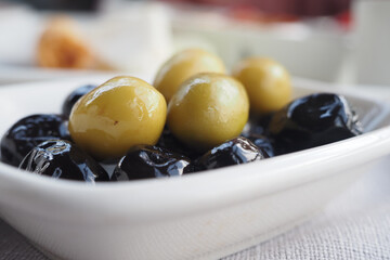 Olives displayed on a plate at a Mediterranean restaurant