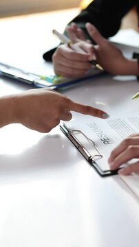 Employer explaining job description during interview. HR managers read resumes and asks candidates questions.