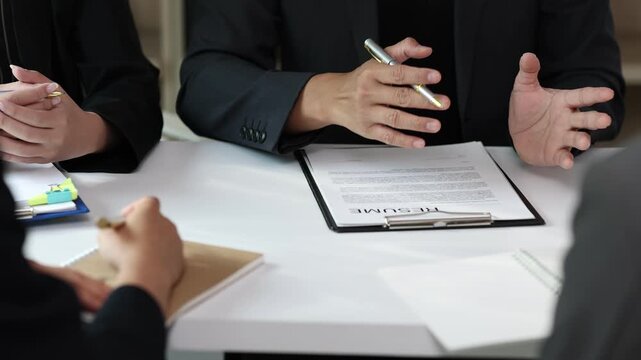 Employer explaining job description during interview. HR managers read resumes and asks candidates questions.