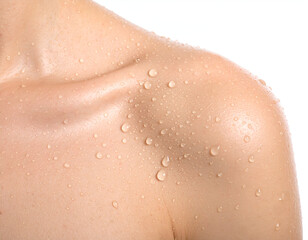 Fototapeta premium close up of female shoulder with fresh water droplets and healthy smooth skin on isolated white background