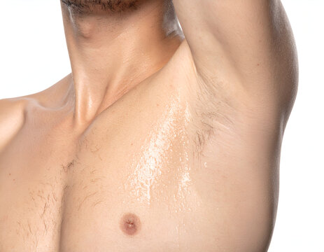 close up of male armpit and chest with wet sweaty skin on isolated white background - Powered by Adobe